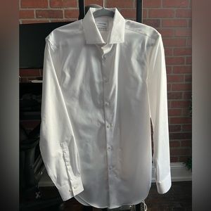 Calvin Klein white button down long sleeve shirt. Size slim fit medium.